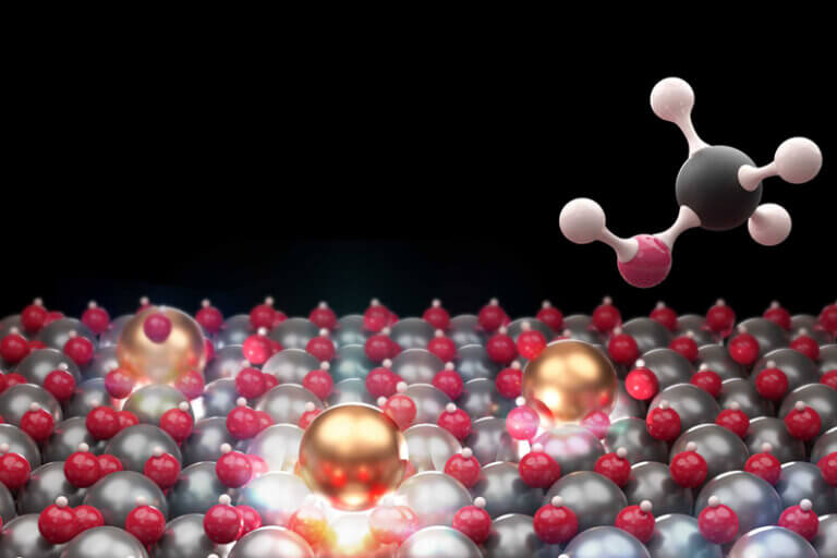 Representação gráfica de átomo isolados de índio (na cor dourada) e metanol para ilustrar que um novo catalisador usa átomos individuais para converter CO2 em metanol.
