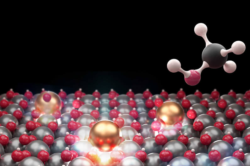 Representação gráfica de átomo isolados de índio (na cor dourada) e metanol para ilustrar que um novo catalisador usa átomos individuais para converter CO2 em metanol.
